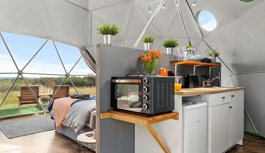 Inside of a dome looking at the luxury glamping kitchen accommodations