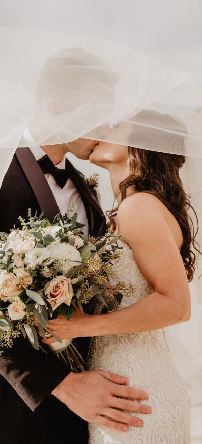 Bride and Groom. The Bride is holding a bouquet of flowers